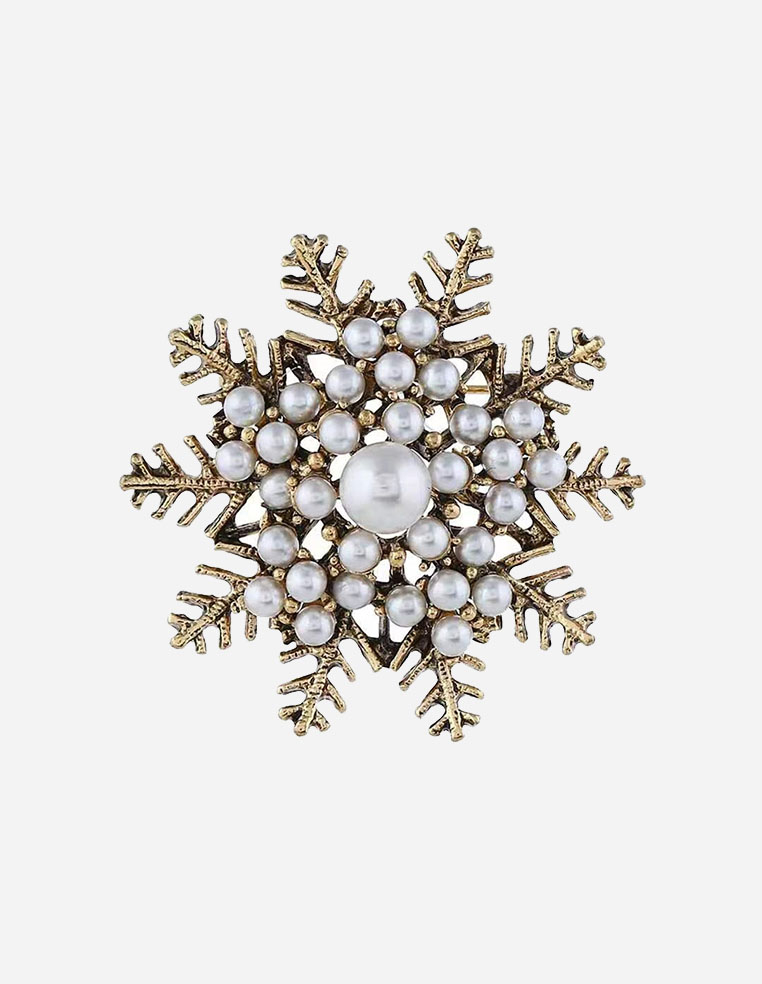 Broche dorée pour femme en forme de flocon de Noël